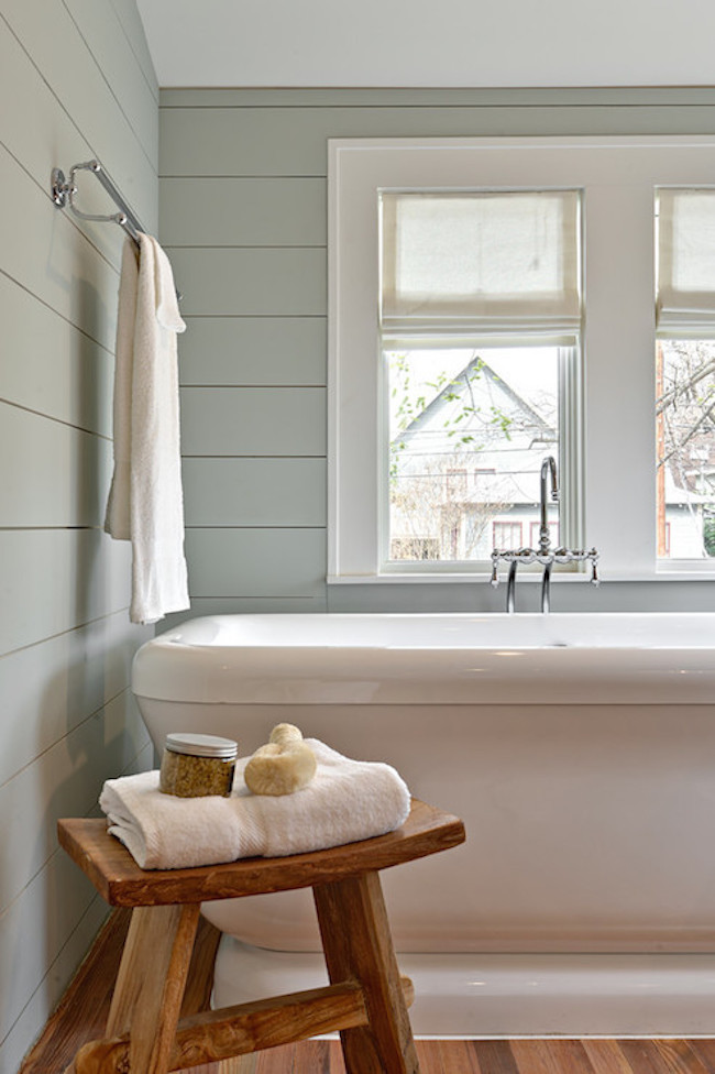 Rustic zen style stool beside tub