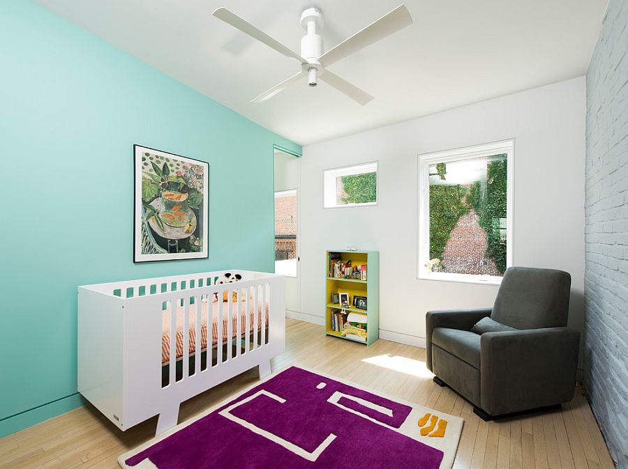 Scandinavian nursery with turquoise accent wall, brick wall and purple rug