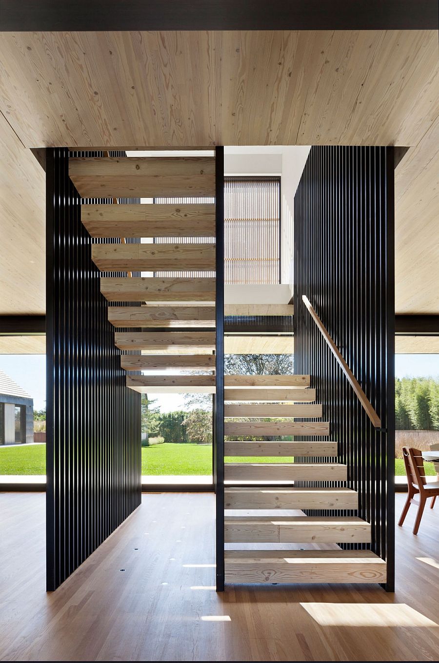 Sculptural steel and wooden staircase of the barn-style home
