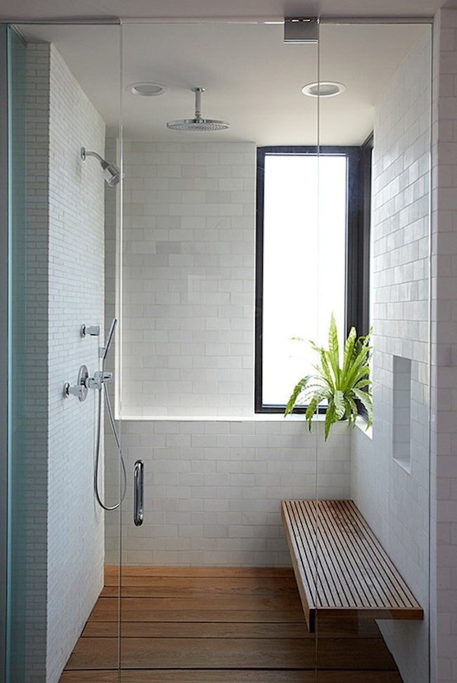 Simple but large shower with wood bench