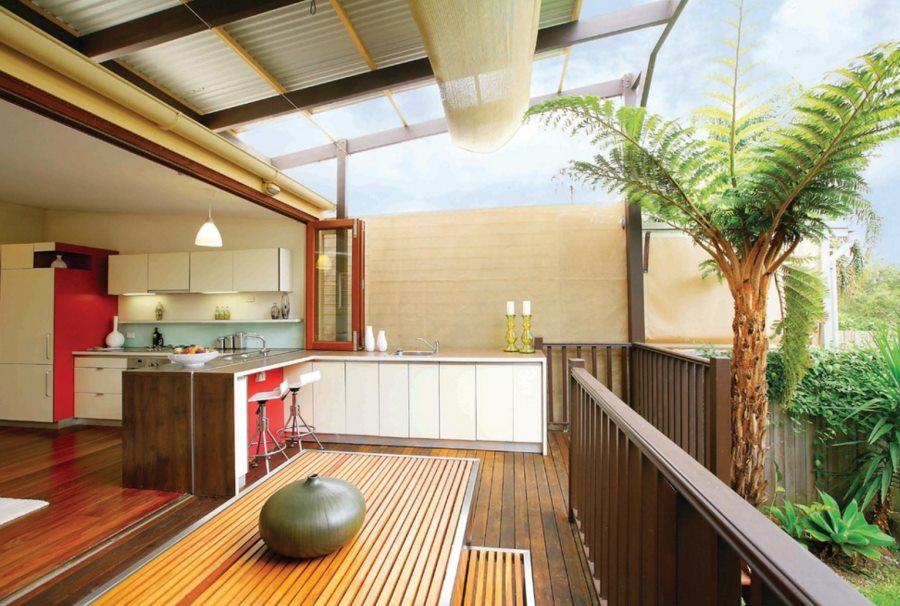 Slatted dining table and bench on a modern deck