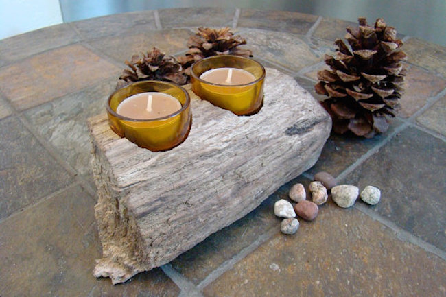 Small natural piece of beach driftwood holding two candles