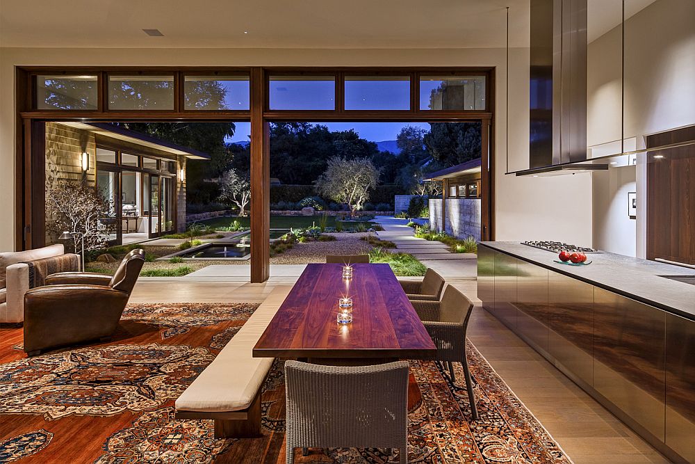 Sparkling dining area and living zone connected with the landscape outside