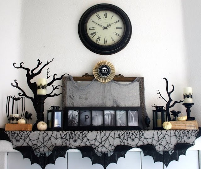 Spooky black cobweb Halloween decor for a fireplace mantel