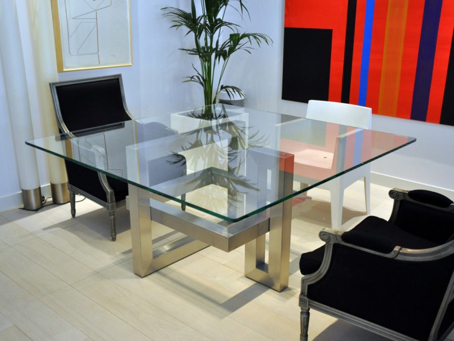 Square dining table with a sculptural base