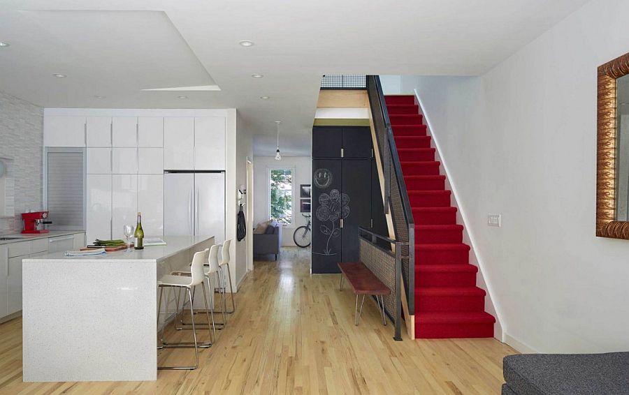 Stairway runner in red and a chalkboard wall provide contrast in the neutral setting