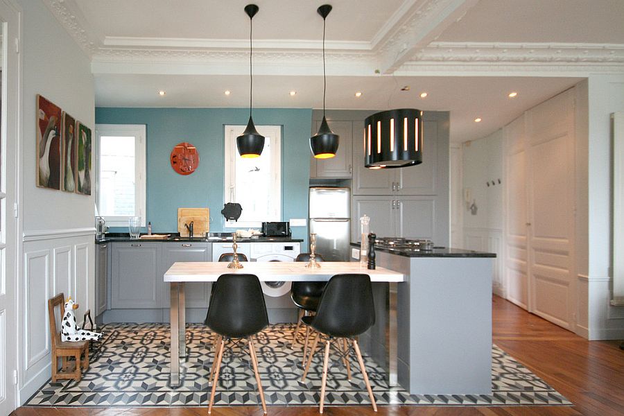 Tom Dixon pendant lights and Eames chairs grace the chic eclectic kitchen