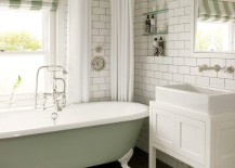 Traditional-clawfoot-tub-in-a-bathroom-with-subway-tile-217x155