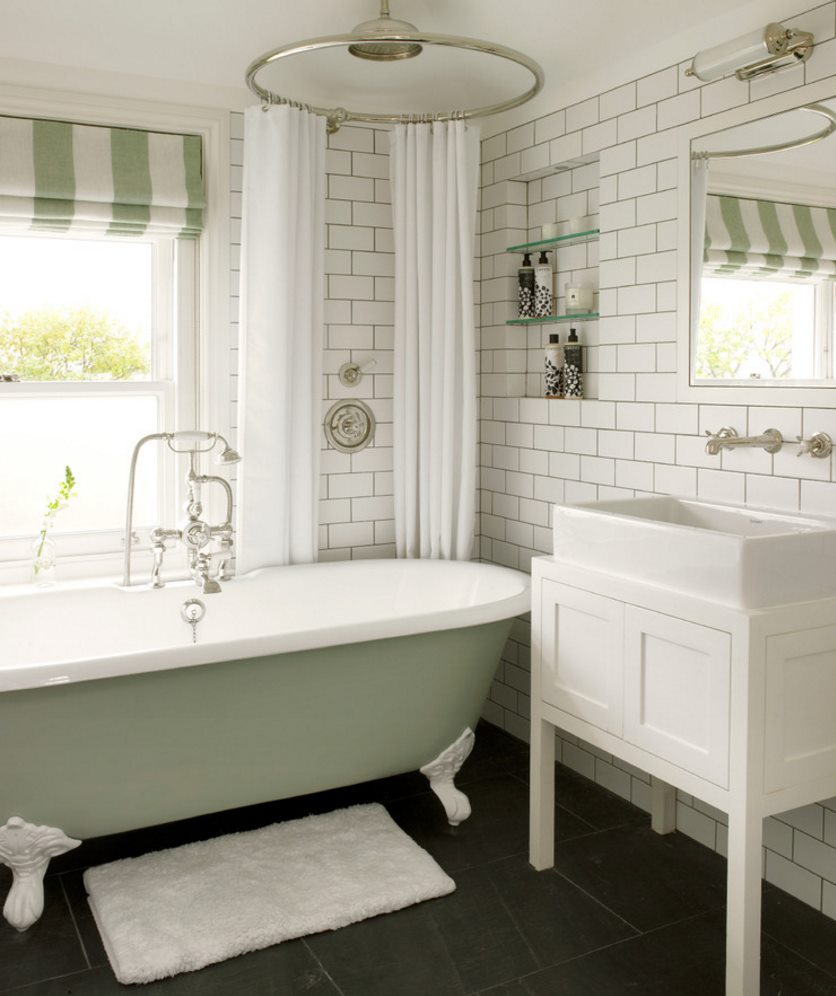 Traditional clawfoot tub in a bathroom with subway tile