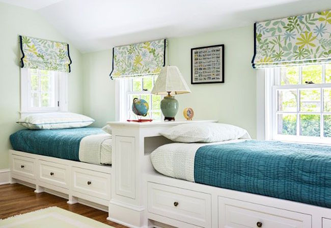 Two twin beds along one wall with extra storage