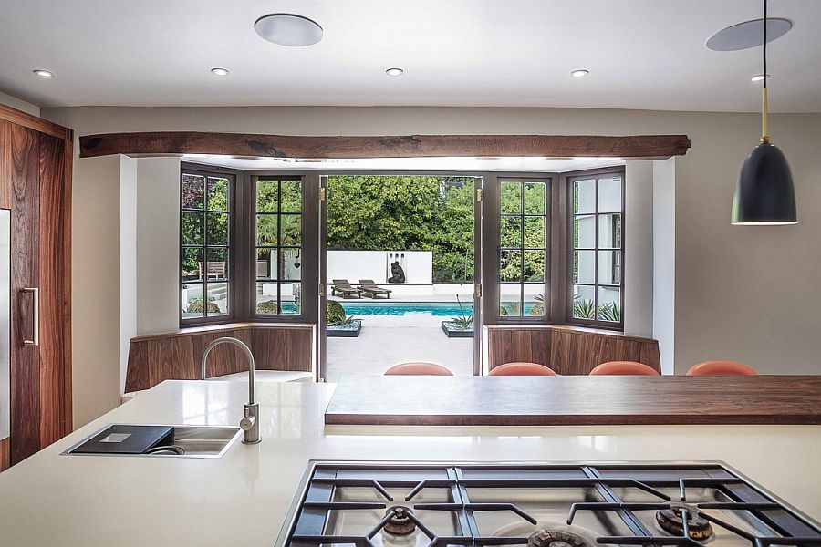 View of the backyard and the pool from the kitchen and dining space