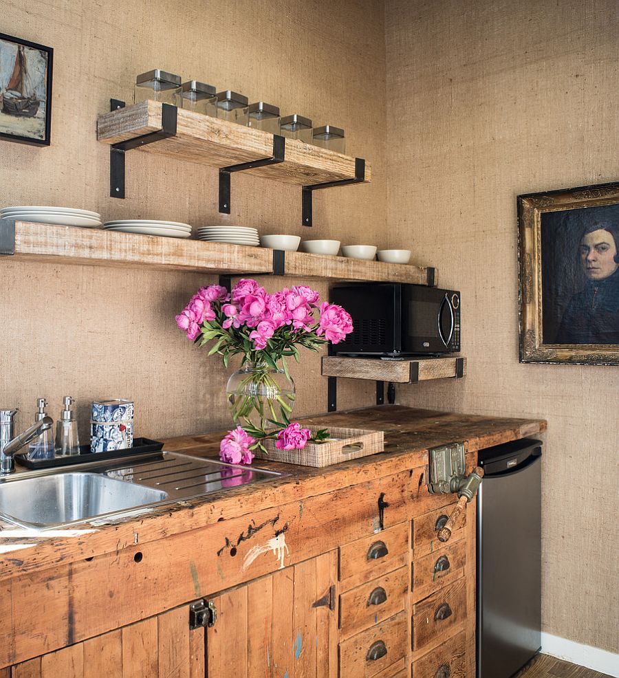 Walls covered in burlap and vintage kitchen cabinets shape the lovely kitchen [Design: Antonio Martins Interior Design]