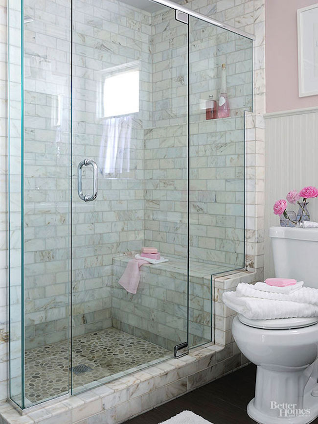 White marble tiled walk-in shower with built-in bench