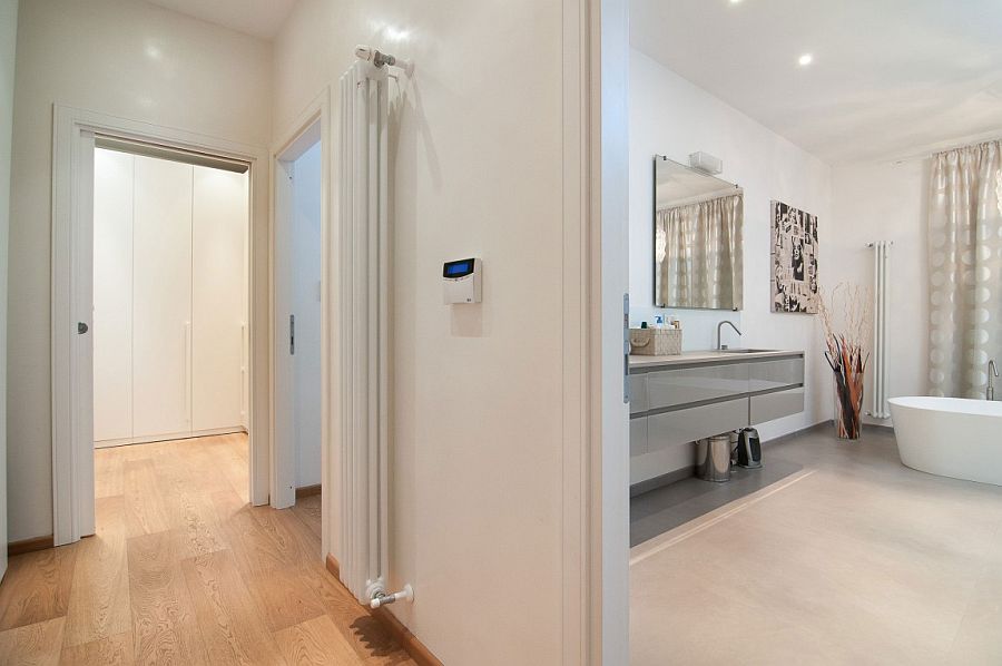 White walk-in closet and bathroom borrow from the style of the living room