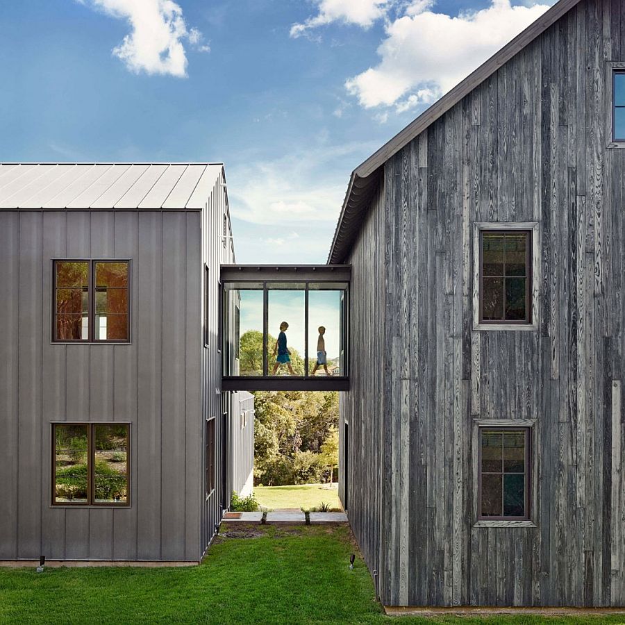 A glass walkway bridges the two farmhouse-styled structures of the home