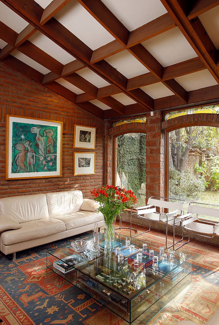 Arched window design brings classic elegance to the living room with brick walls [Design: Carolina Katz + Paula Nuñez]