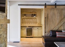 Barn-door-leads-to-the-small-home-bar-in-the-living-room-217x155