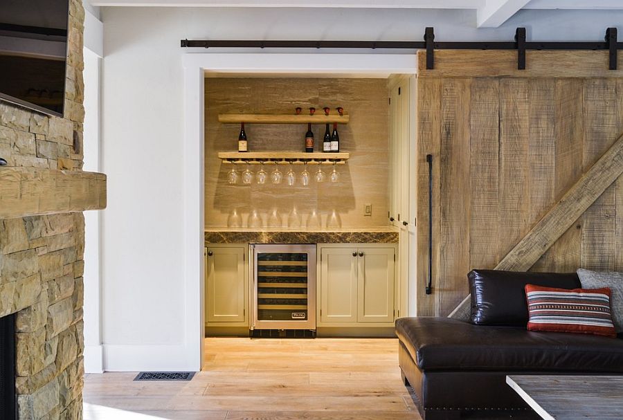 Barn door leads to the small home bar in the living room