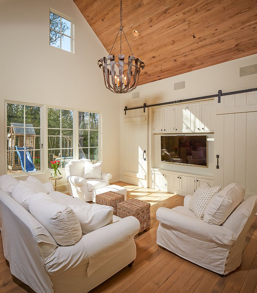 Barn doors slide open to reveal the television [Design: Thompson Custom Homes]