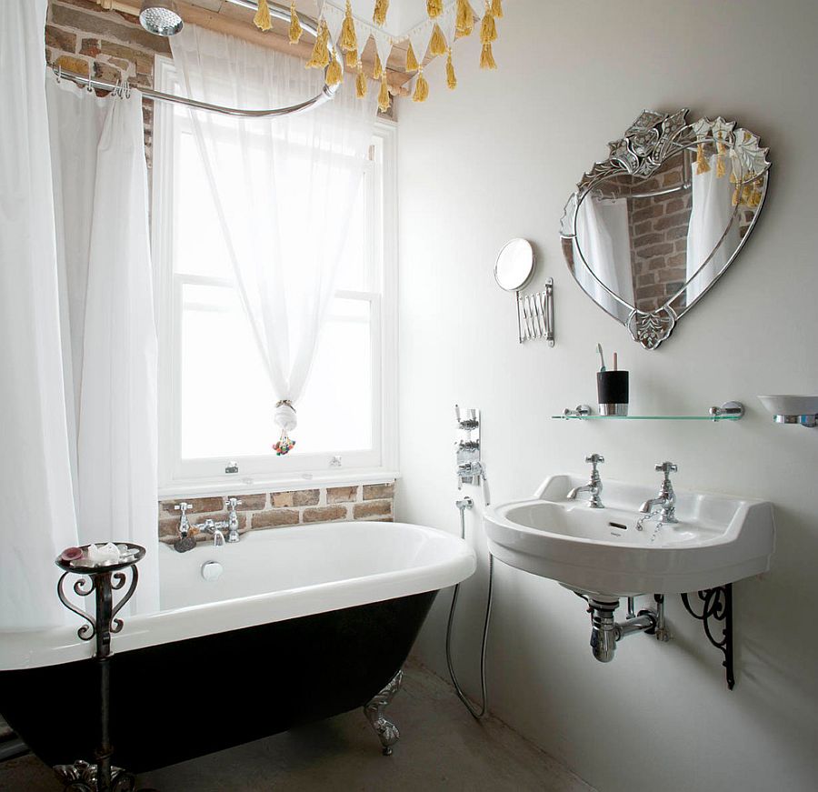 Bathroom with brick wall, white sheer curtains and vintage bathtub in black