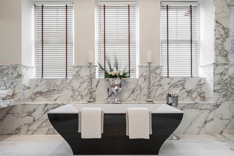 Beautiful contemporary bathtub in black set against a marble backdrop