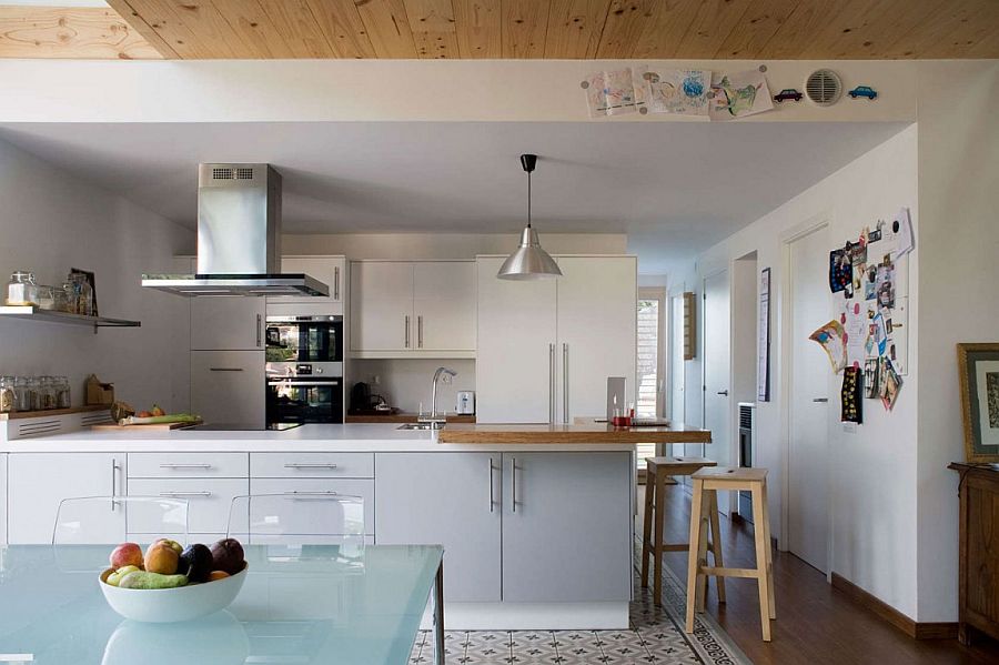 Beautiful contemporary kitchen in white with a smart peninsula and floating shelves