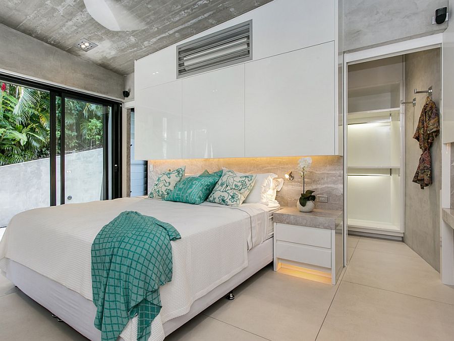 Bedroom in white with concrete ceiling at the Edge