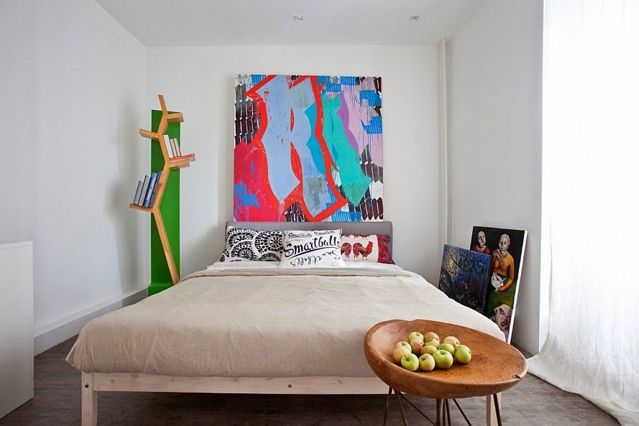 Bedroom in white with large modern art piece for the headboard wall