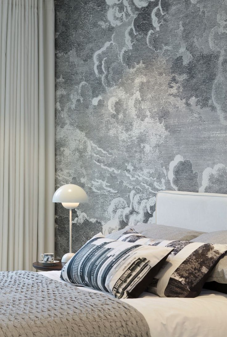 Bedroom with cloud wallpaper by Fornasetti at Cole & Son