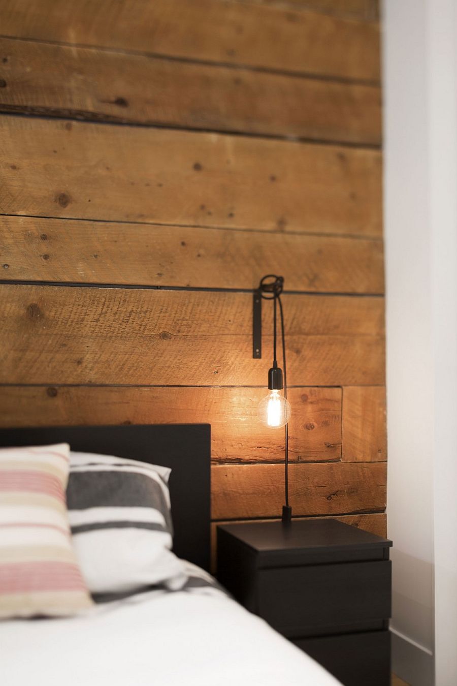 Bedside table and lighting add a touch of industrial charm