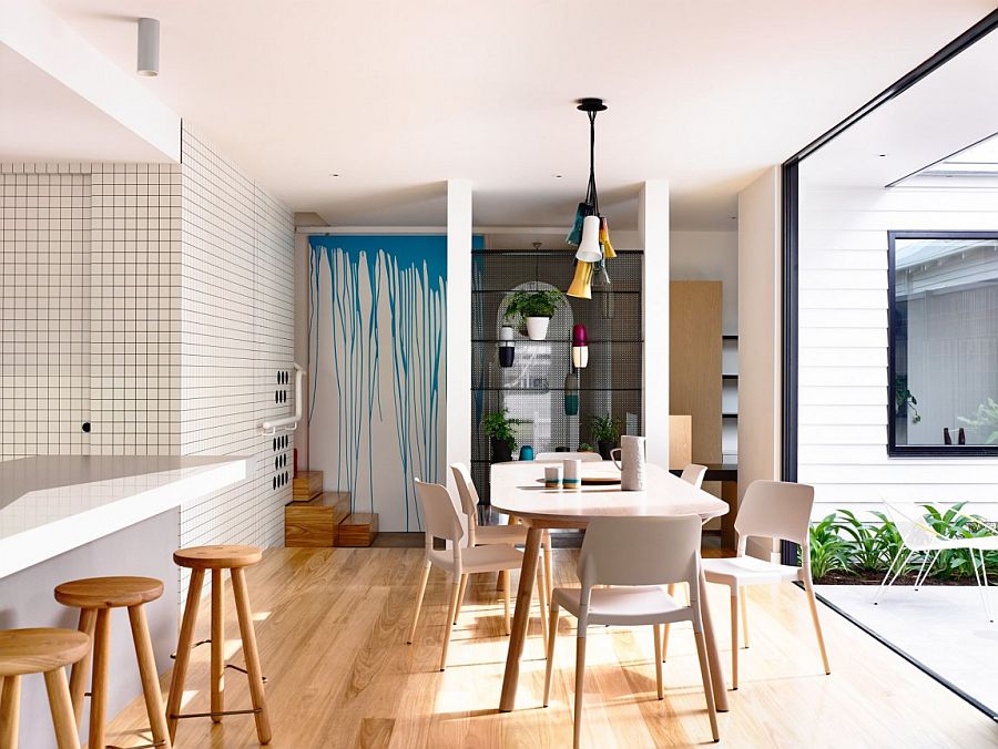 Bespoke door with paint-drip design and a breezy dining space connected with the patio