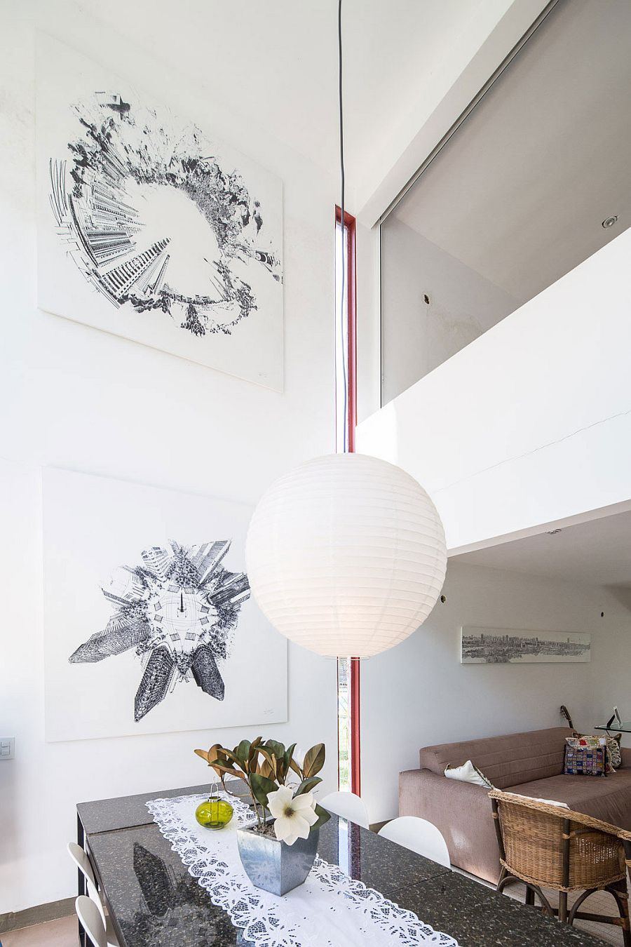 Black and white artwork creates a gallery style wall in the dining space