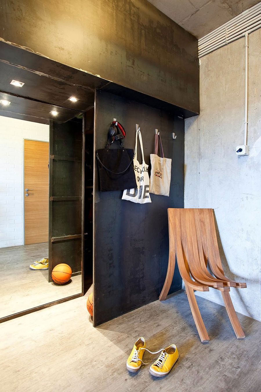 Black metal wall separates the living space from the entrance