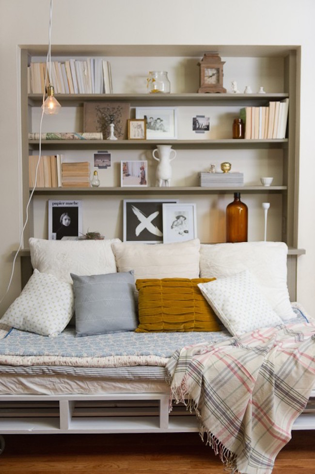 Bookshelf with bed positioned up against it from one side