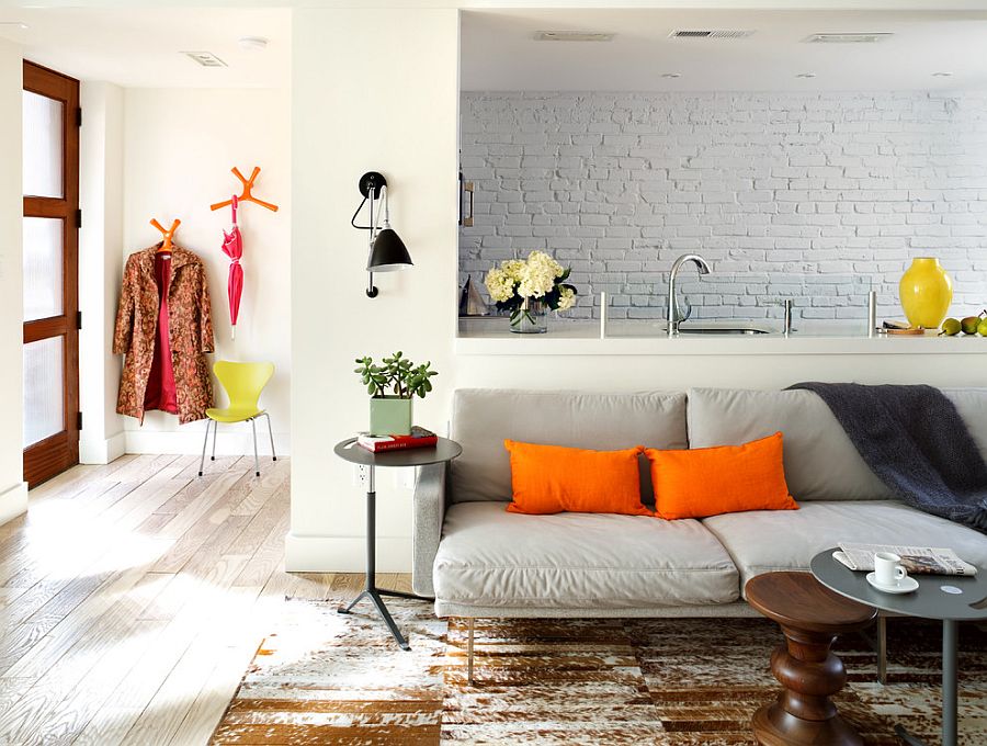 Brick wall in the backdrop becomes a part of the living room visual [Design: Donald Lococo Architects]
