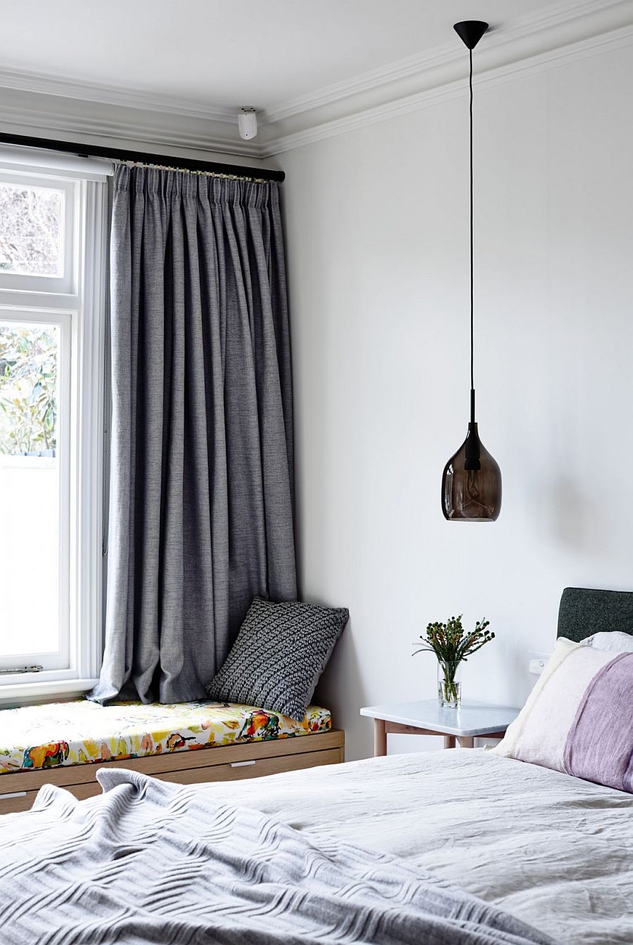 Chic contemporary bedroom with bedside pendant lighting and window seat