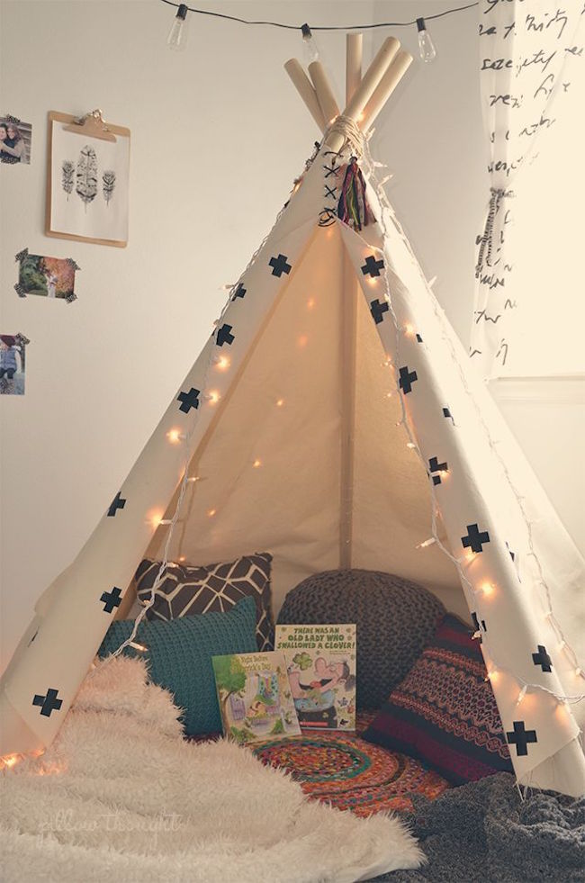 Classic and simple teepee stocked with pillows and books