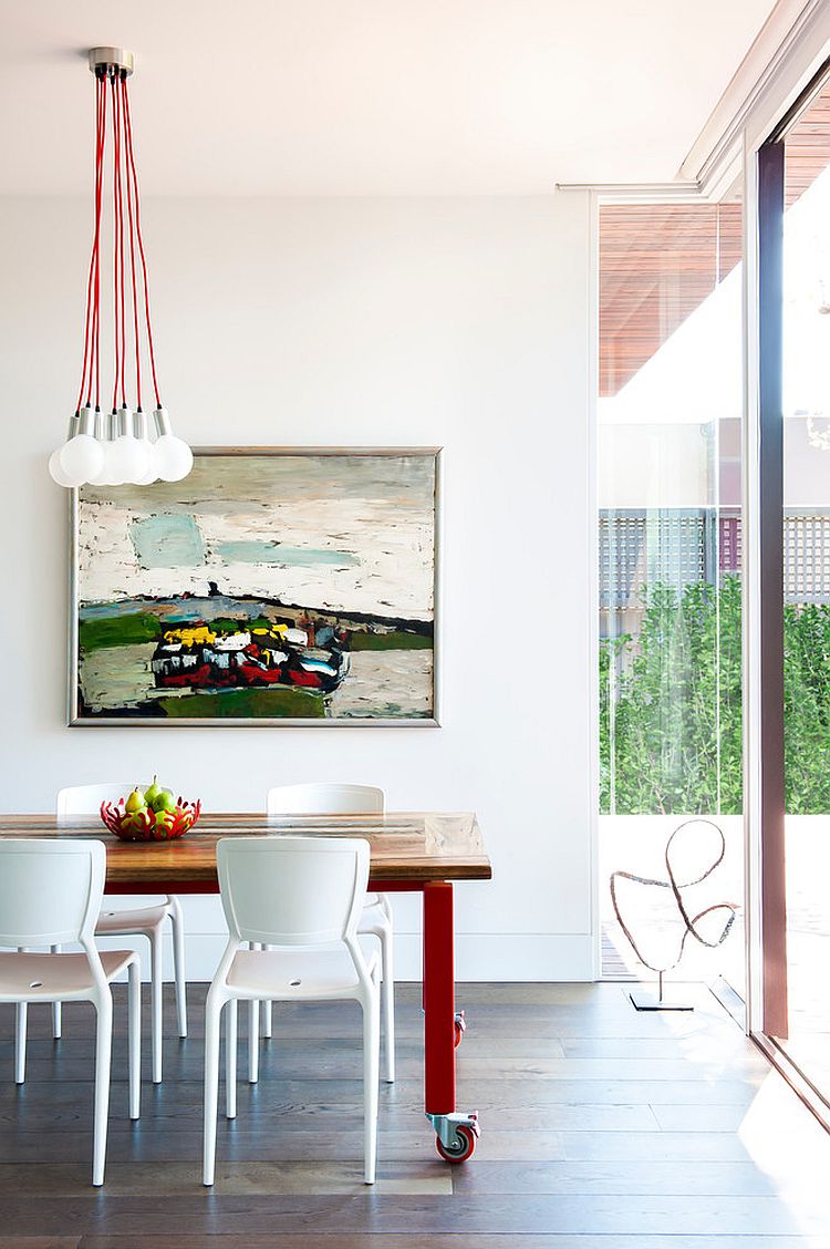 Contemporary dining room in white with lovely use of red accents