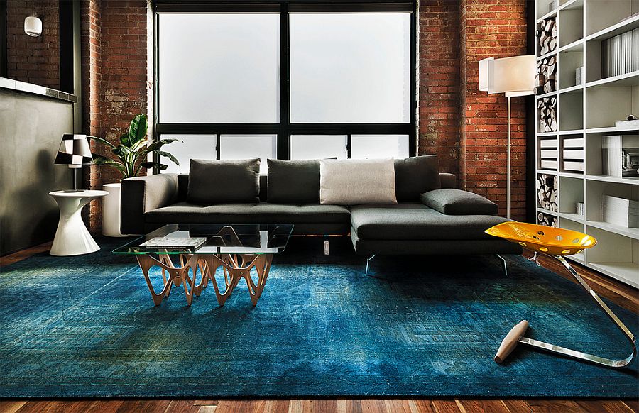 Contemporary living space with rug in copper blue and plush sofa in dark gray