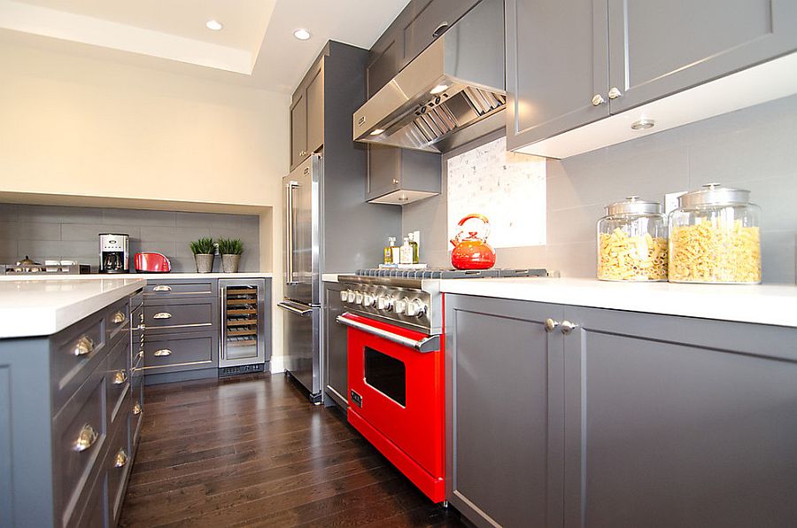 Cool gray kitchen cabinets coupled with a hint of red [Design: Odenza Homes]