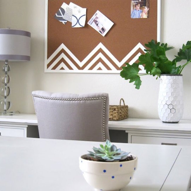 Cork board with white zigzag designs at the bottom