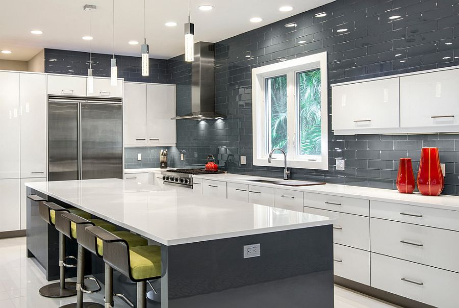 Dark and glossy backsplash in the kitchen with white and gray cabinets [Design: BUILD / Amber Frederiksen Photography]