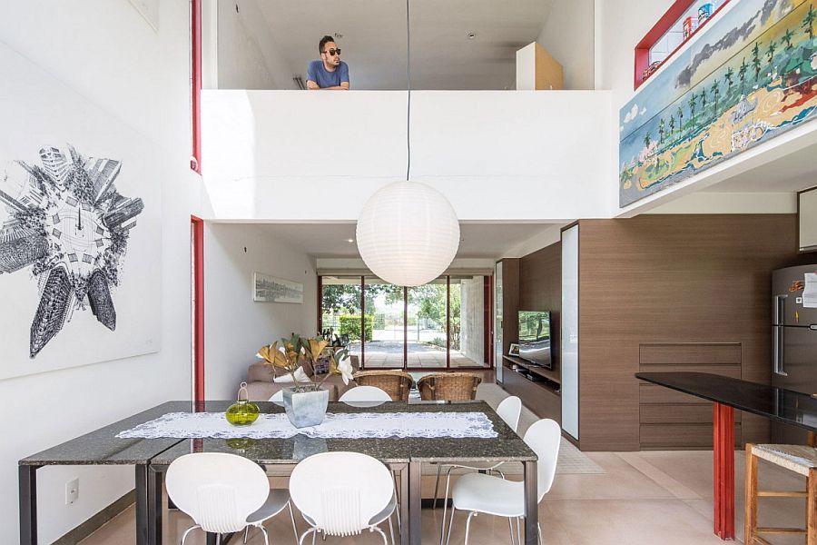 Double height dining area becomes the main social zone in the house