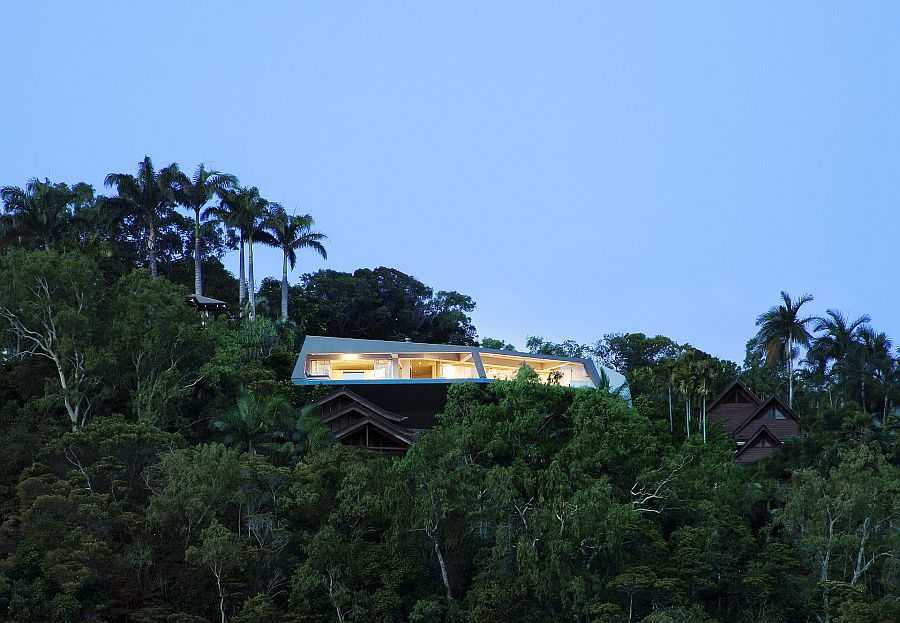 Fabulous futuristic home nestled among green canopy and overlooking Port Douglas in Queensland