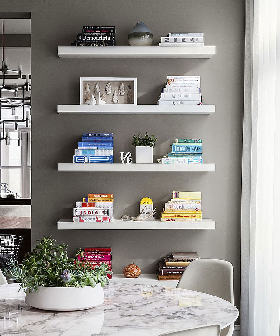 Floating white shelves in the dining room add grace and minimalist style