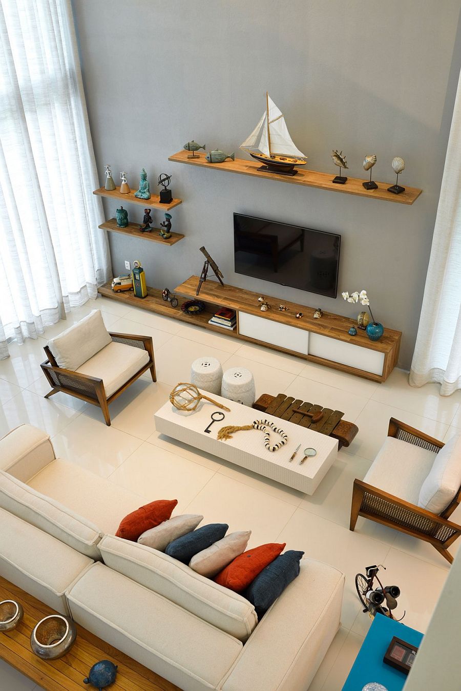 Floating wooden shelves in the living room with nautical themed decoration