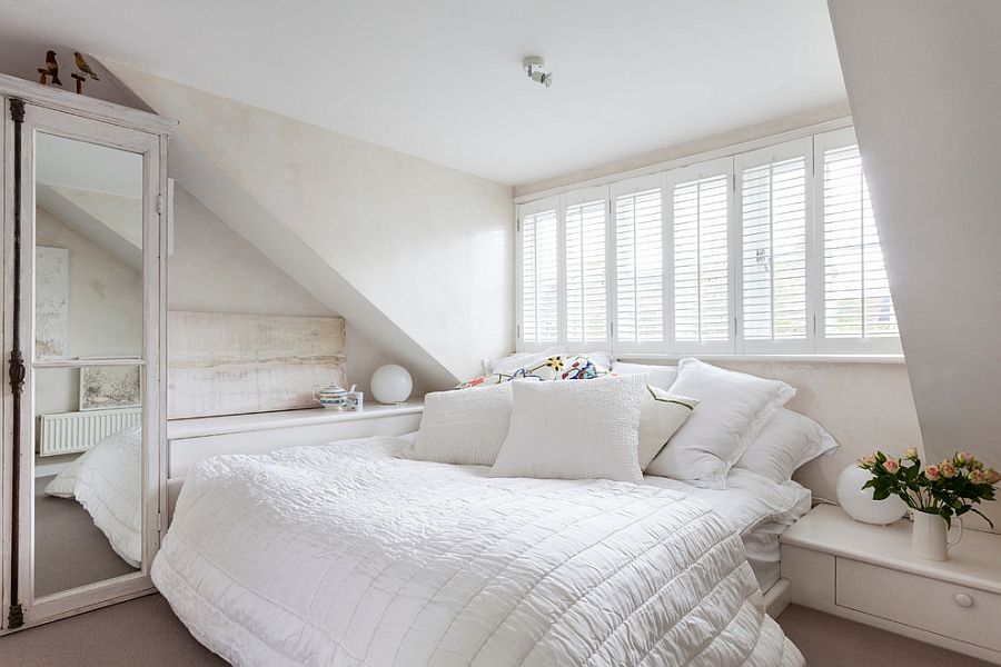 Glass-fronted door of the antique cabinet adds a lovely focal point to the feminine bedroom [Photography: Chris Snook]