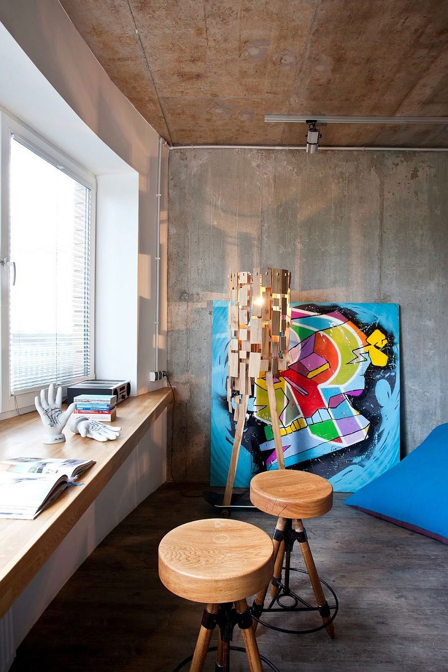 Gorgeous floor lamp and colorful art work add character to the interior