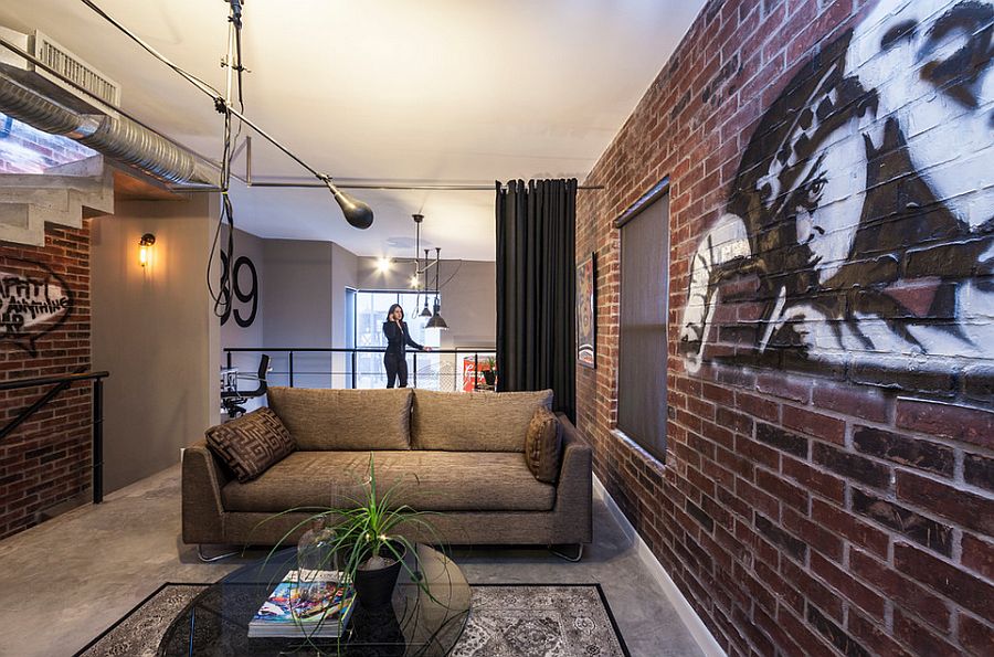 Graffiti on the walls makes for a great addition in the living room with brick walls [Design: CityLoft]