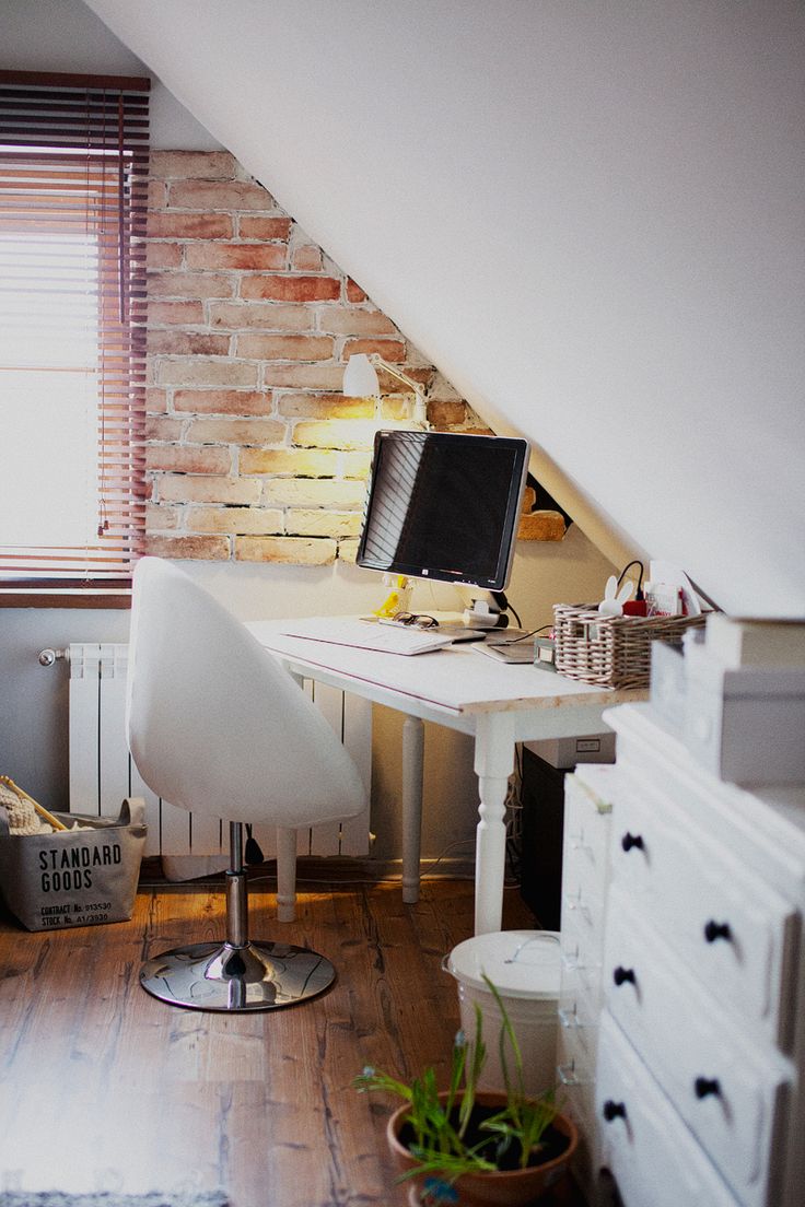 Home office nook in an attic with brick wall exposed